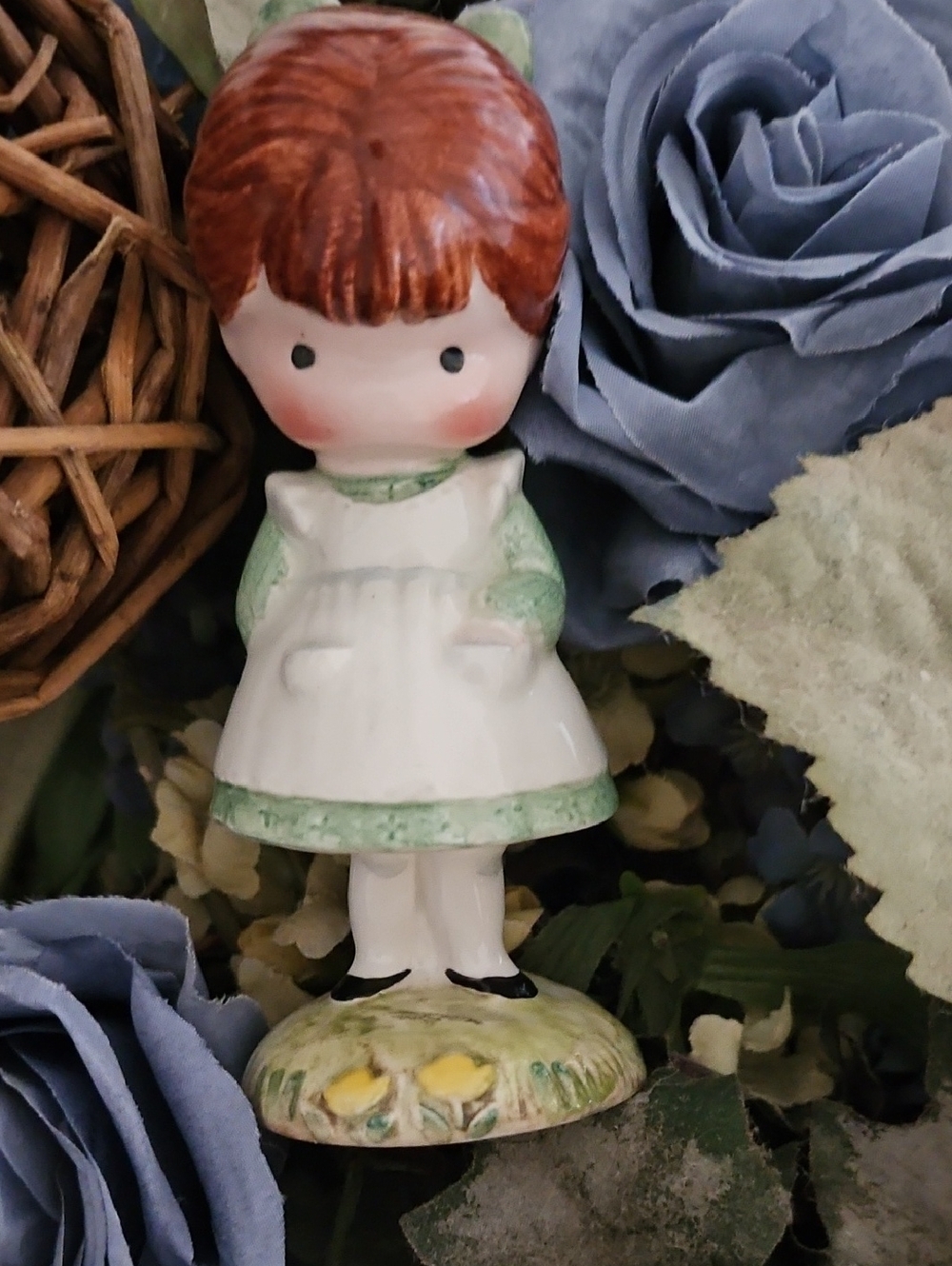 Porcelain Girl Figurine in White and Green Dress Holding A Doll Behond Her Back